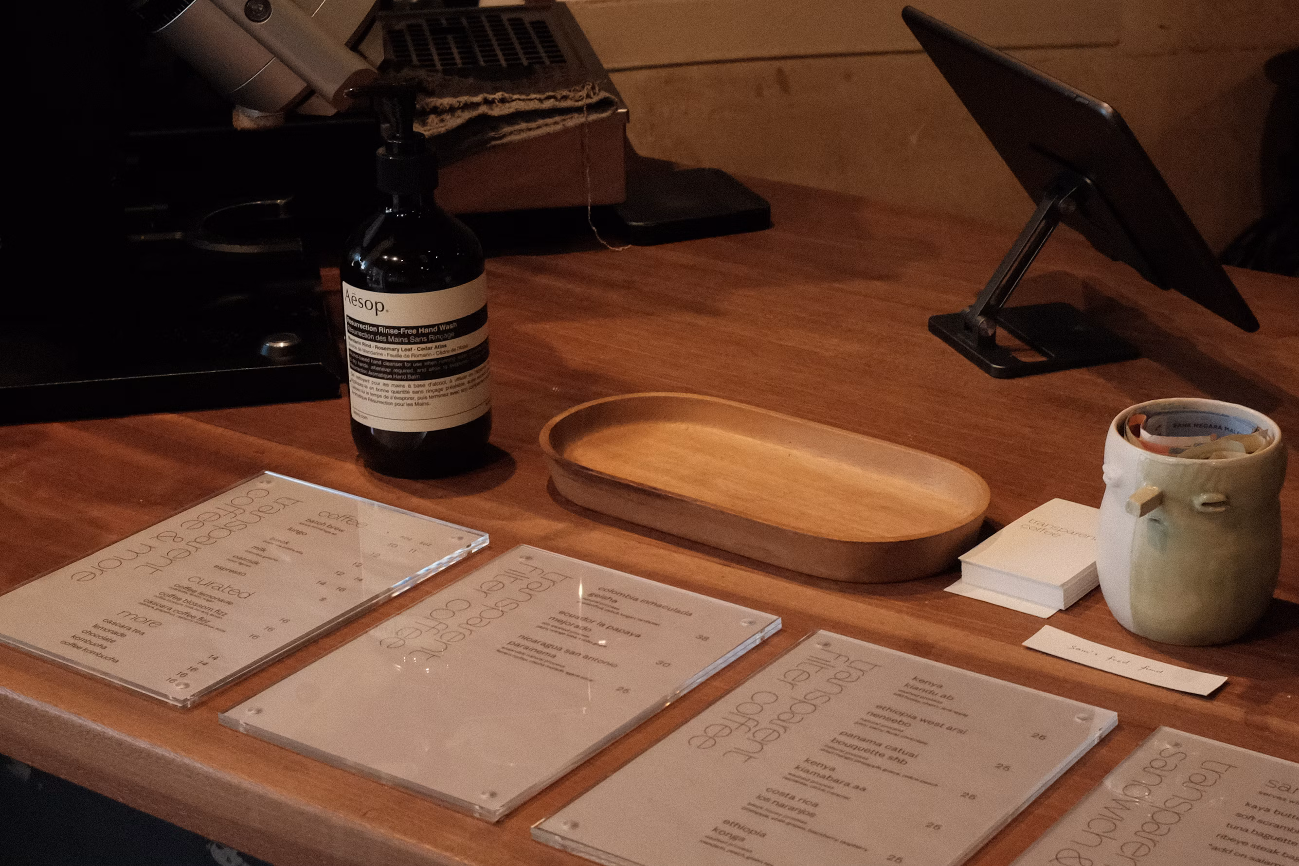 printed menu boards mounted on the wall above a café counter